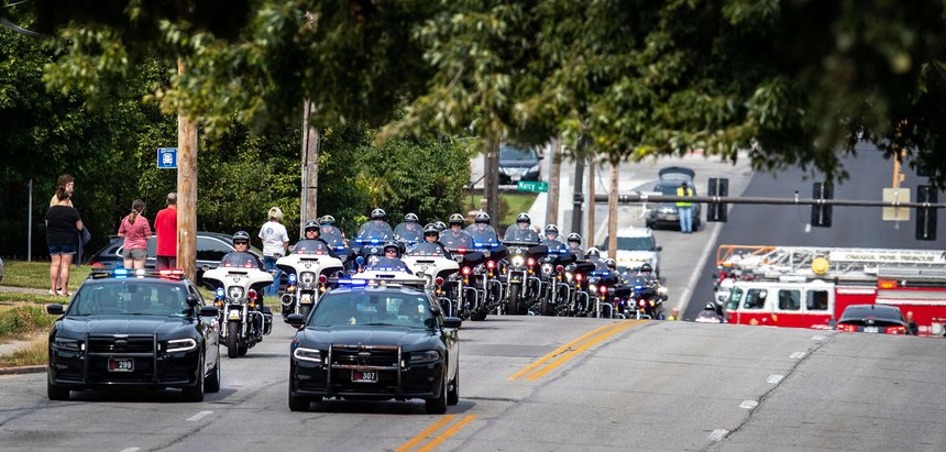 People stand out on 42nd Street north of Pacific street to watch as Omaha police officers escort the body of Lincoln police officer Mario Herrera back to Lincoln after he died on Monday, Sept. 7, 2020.