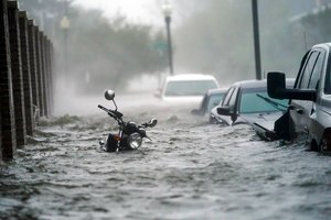 Cars and a motorcycle are are submerged in floodwaters on a street, Wednesday, Sept. 16, 2020, in Pensacola, Fla. Hurricane Sally made landfall Wednesday near Gulf Shores, Alabama, as a Category 2 storm, pushing a surge of ocean water onto the coast and dumping torrential rain that forecasters said would cause dangerous flooding from the Florida Panhandle to Mississippi and well inland in the days ahead.
