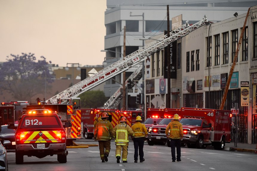 LAFD firefighters work the scene of a structure fire that injured multiple firefighters, according to a fire department spokesman, Saturday, May 16, 2020, in Los Angeles.