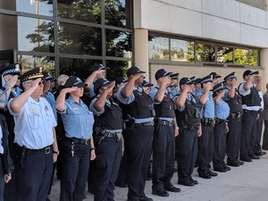 Officers salute the colors during a 9/11 memorial flag raising ceremony. (image/GovX)
