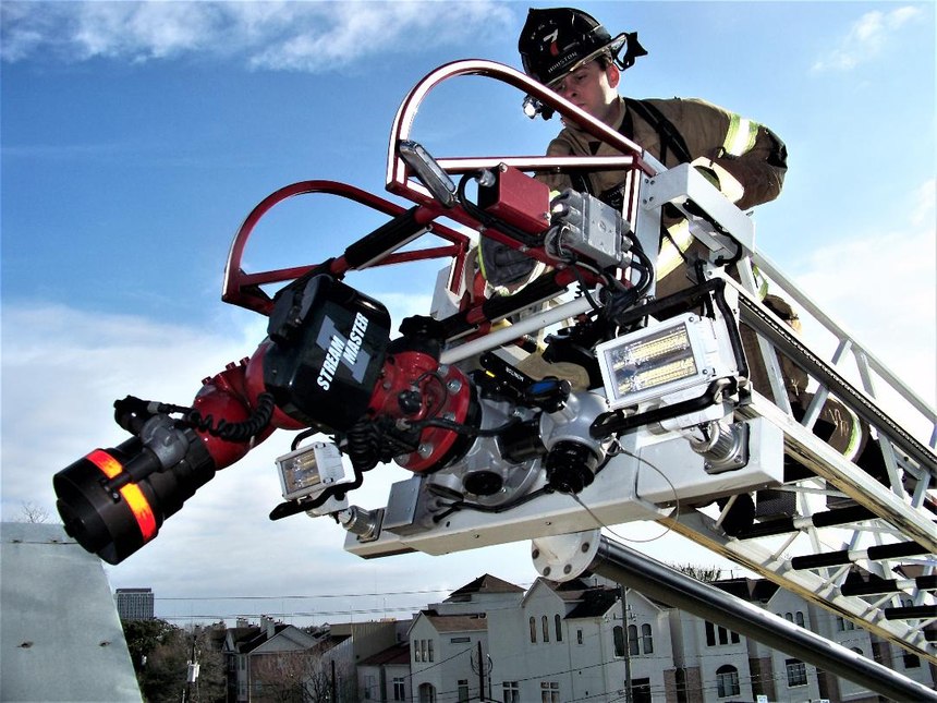 It is absolutely safe to assign firefighters to the tip of the ladder during aerial master stream operations. Most aerials are rated for 500 pounds while flowing water. It is also acceptable to raise lower and rotate while a firefighter is on the tip. Such operations will typically be slow movements.