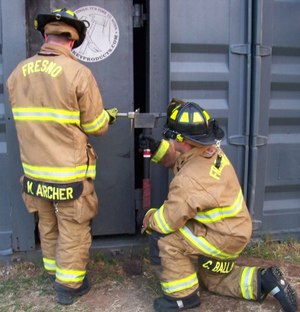 Figure 11: When a two-person team is being utilized, it is imperative that the firefighter swinging the axe takes a kneeling position.