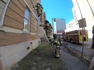 When conducting VEIS via a second-floor window, the search firefighter should proceed up the ladder first, followed closely by the officer with a TIC.