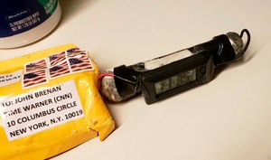 This image obtained Wednesday, Oct. 24, 2018, and provided by ABC News shows a package addressed to former CIA head John Brennan and an explosive device that was sent to CNN's New York office. The mail-bomb scare widened Thursday as law enforcement officials seized more suspicious packages. (ABC News via AP)