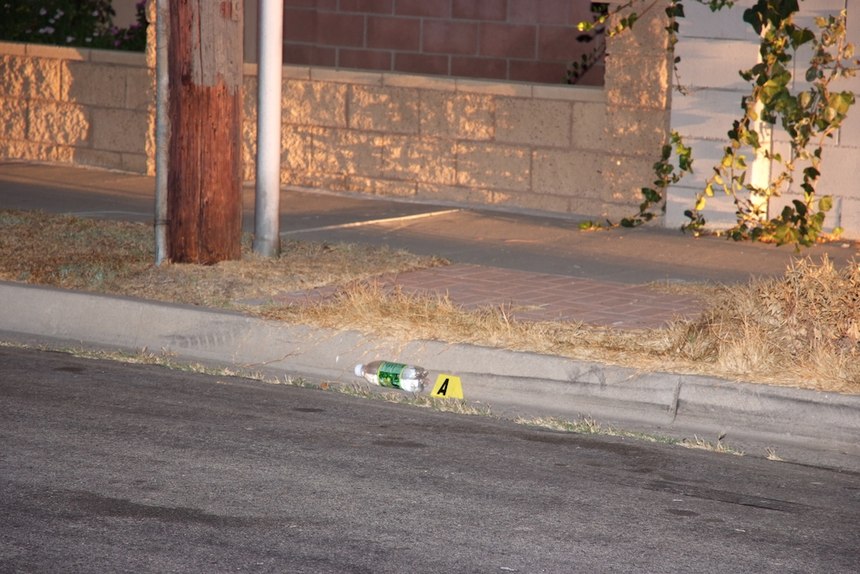 A crime scene photo showing the starting location of the incident. Note the skid mark in the street and the bottle in the gutter. Photo courtesy of Anaheim City Attorney’s Office.