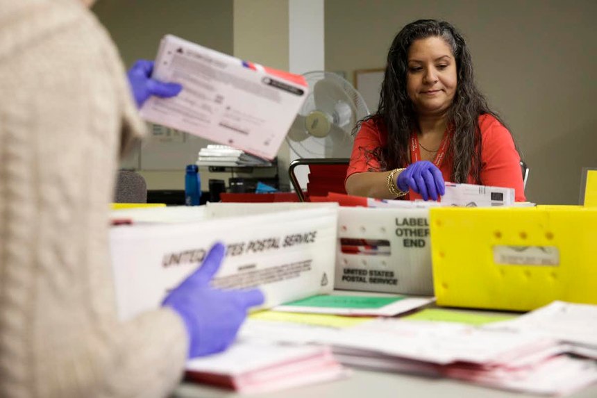 Election workers sort mailed-in ballots in Washington state on March 10. Image: Jason Redmond/AFP via Getty Images