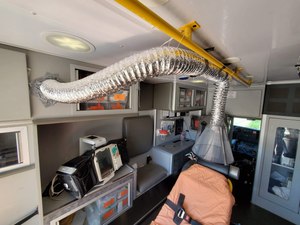 This device focuses the ambulance exhaust fan directly over the patient’s head to help draw out aerosols as they are generated. (Photo/Jamie Lee, Cumming, GA)