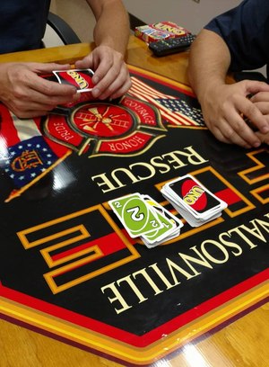 Deployed firefighters bunked in firehouse bays and played cards to decompress after 16-hour days.