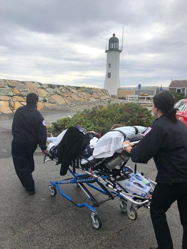 Laura Mullins is wheeled to the Scituate Lighthouse.