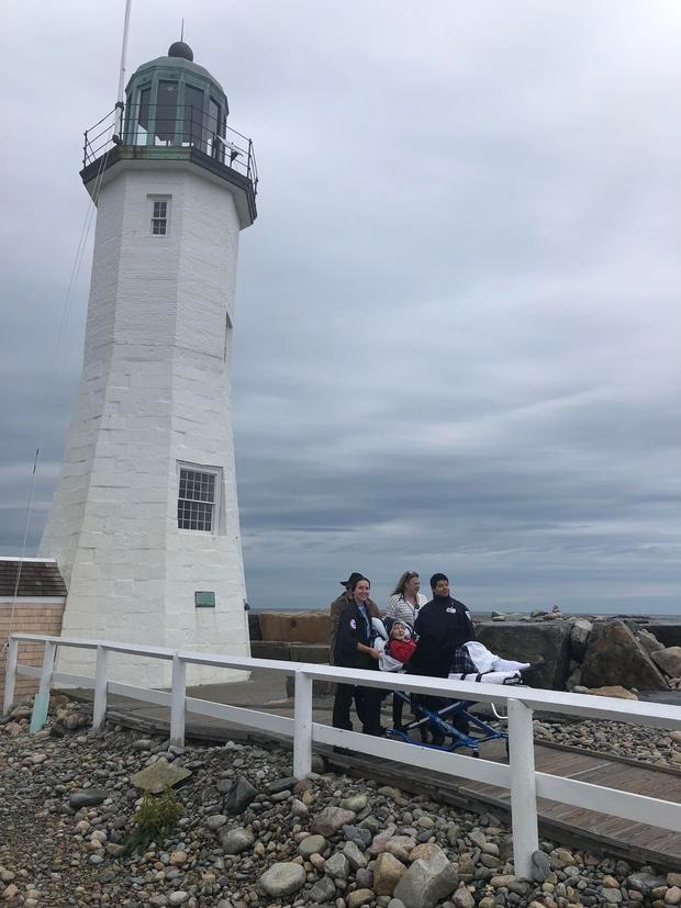 Laura Mullins is wheeled from the Scituate Lighthouse.