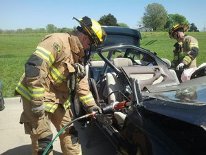 Two Lee's Summit firefighters practice vehicle extrication.