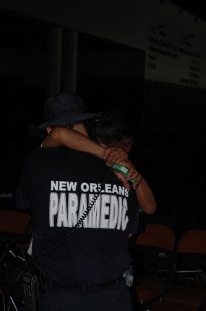 Nick Culotta, former paramedic for the New Orleans Health Department, shares a special moment with an evacuee during Hurricane Katrina response efforts. (Photo/Miles Jeffery Watts, Jr.)