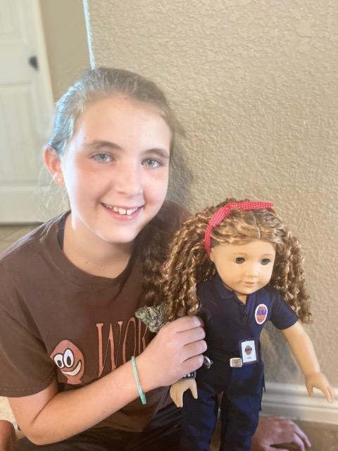 EMT April O'Quinn's niece Lacey with the American Girl doll made in O'Quinn's likeness.