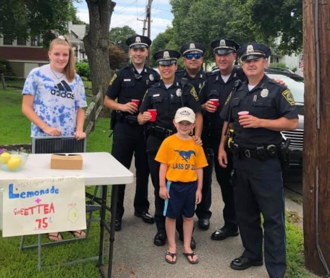 Five-year-old Seamus is pictured with Norwood PD officers.