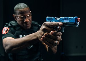 officer with blue Laser Shot simulated weapon