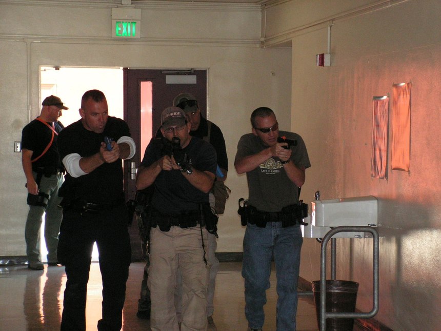 These officers are practicing how to move through a hallway as part of an ad hoc contact team. 