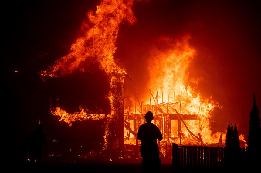 A home burns as the Camp Fire rages through Paradise, California in November 2018.