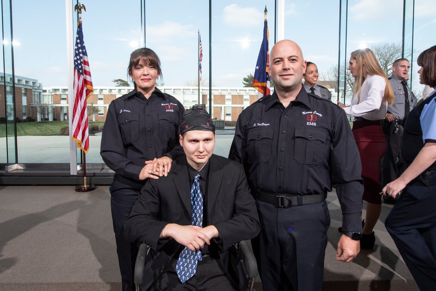 Judy Ortiz and Adam Van Duzen of Morrow County (Ohio) EMS stand next to Ohio State Trooper Jason Phillips at the award ceremony.