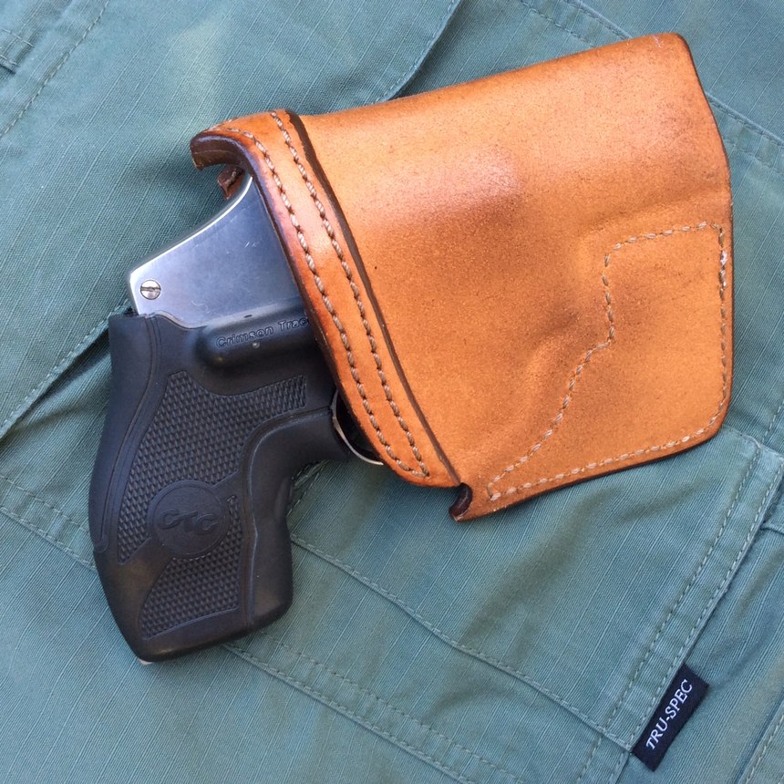 A holster is an absolute necessity for a snubby carried in a pants pocket. It will keep the gun oriented properly for the draw, break up its outline and protect the gun from damage and debris. The Crimson Trace LaserGrips on this example are an excellent addition to a BUG that might have to be fired from awkward or “broken” shooting positions. (Photo/Mike Wood)