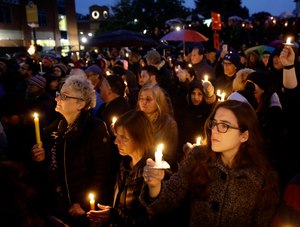 eople hold candles as they gather for a vigil in the aftermath of a deadly shooting at the Tree of Life Congregation, in the Squirrel Hill neighborhood of Pittsburgh, Saturday, Oct. 27, 2018. (AP Photo/Matt Rourke)