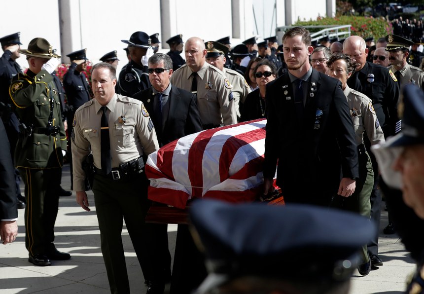 A casket with the body of Ventura County Sheriff's Sgt. Ron Helus is carried into the Calvary Community Church Thursday, Nov. 15, 2018. (AP Photo/Marcio Jose Sanchez, Pool)