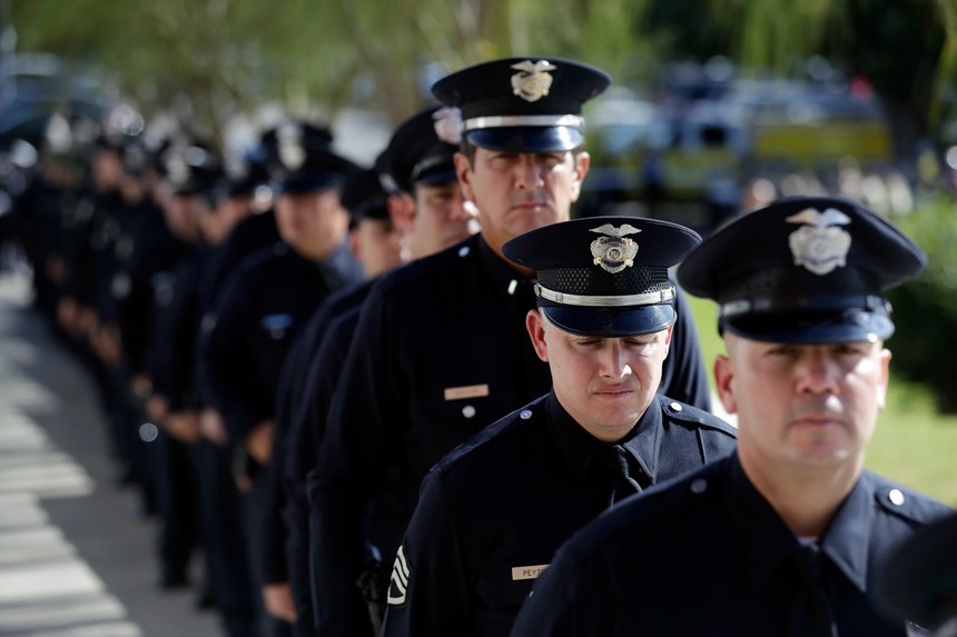 Law enforcement personnel wait to enter the Calvary Community Church for a service in memory of Ventura County Sheriff's Sgt. Ron Helus at Thursday, Nov. 15, 2018. (AP Photo/Marcio Jose Sanchez, Pool)