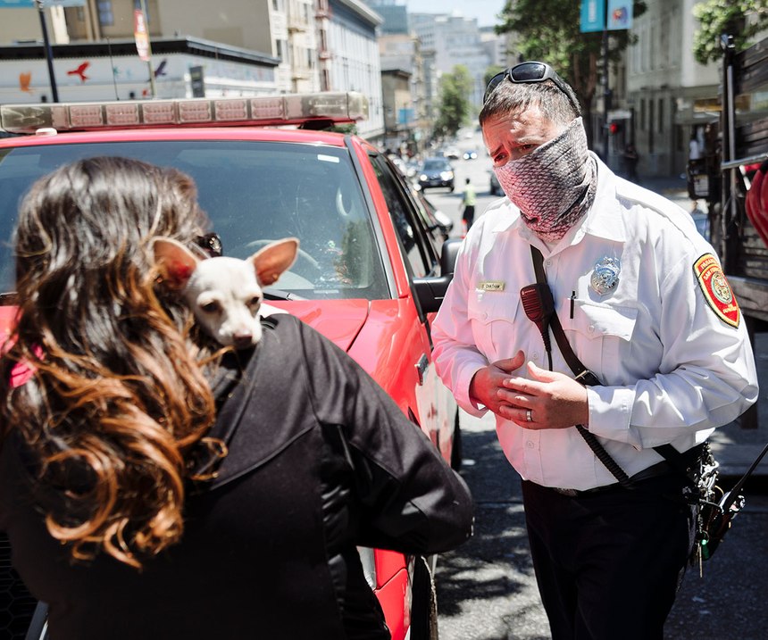 San Francisco Fire Department Captain Brandon Chatham, a community paramedic, talks about shelter options with a woman experiencing homelessness in the city's Tenderloin district