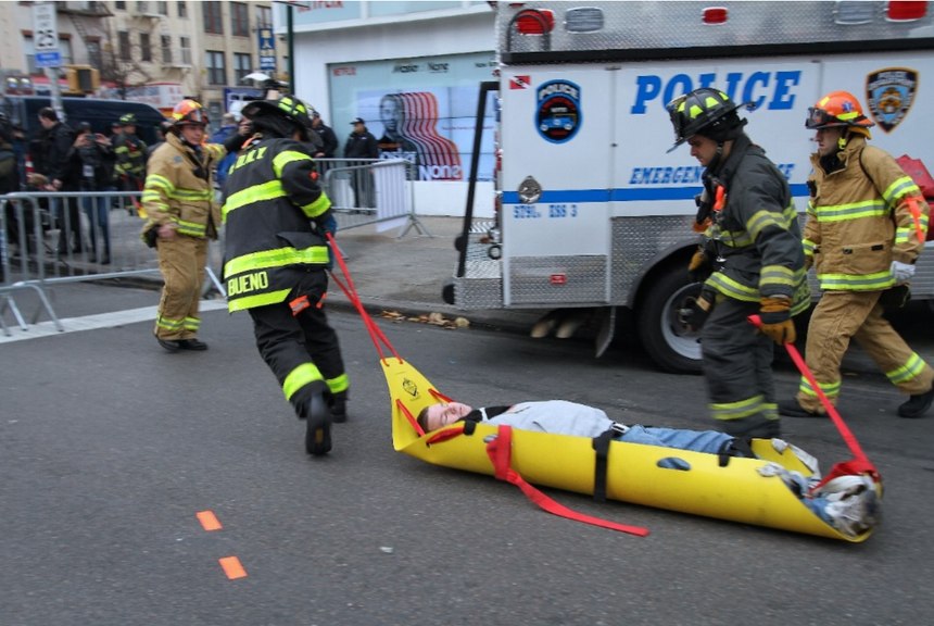 FDNY firefighters and EMTs quickly move a gunshot wounded patient from the warm zone to the ambulance at a full-scale exercise in New York City.