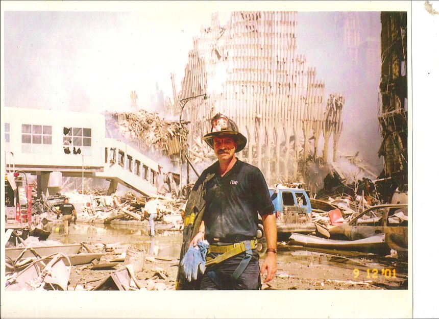 After 9/11, Denis went to Ground Zero to help with search efforts. At one point, he had to go back to his car to get a harness to lower himself into a pit to search for survivors. While going back to the site, he saw a police officer and asked her to take this picture in case he didn’t make it out alive.
