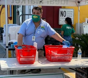 Ben Castro handing out complimentary masks to customers.