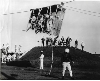 Astronaut Stuart Roosa prepares to skinny down a rope after a Disneyland-type ride at nearly 75 mph from a height of 320 feet.