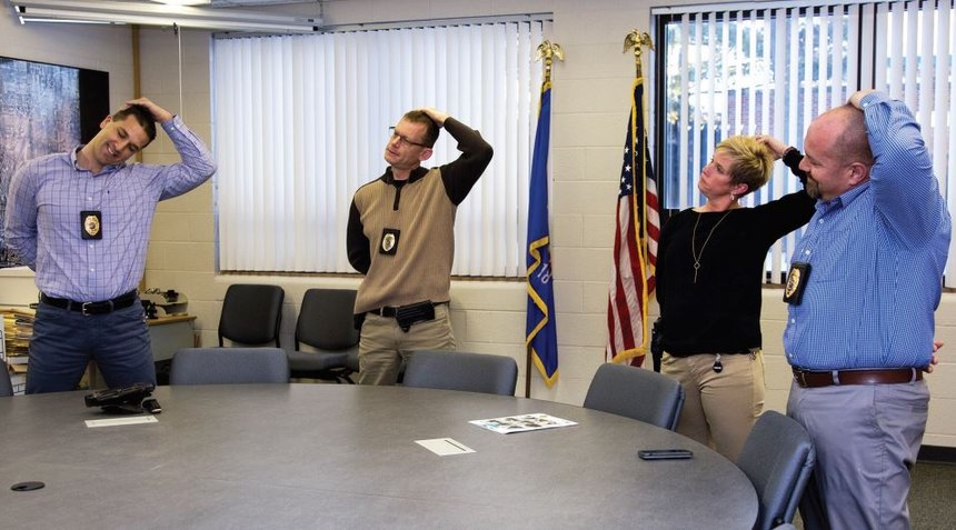Stretching during briefings is a daily occurrence at SPPD. (Photo/Alan Kolbeck)