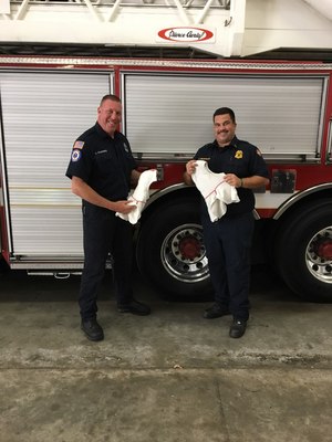 Firefighter/Paramedic Sean Kilgannon and Lt. Rob Neuberger receiving their GORE® Particulate Hoods