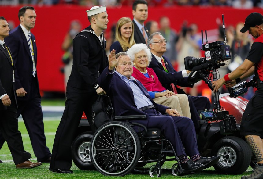 Former President George H.W. Bush and Barbara Bush arrive on the field for the coin toss prior to the NFL Super Bowl LI football game between the New England Patriots and Atlanta Falcons at NRG Stadium on Sunday, February 5, 2017 in Houston, Texas. (Ben Liebenberg via AP)
