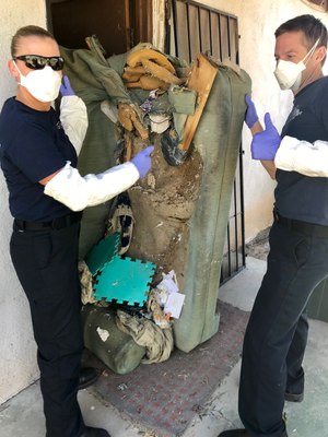Navigators Jenny La Coss and Captain Brian Thompson assist in cleaning up a client's home. Often TC-3 staff will try and fill the gaps in the community and if a service is not provided or not affordable TC-3 will do its part to help the client move forward.