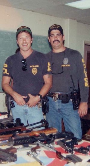 Tim and Bob with a cache of weapons seized from the street. (Photo/comptonpolicegangs.com/)