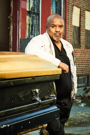 After Terry Starks was shot in 2002, a friend started to drive him to the hospital, but pulled over when he saw a police cruiser. The cop drove him the rest of the way. He is now an anti-violence activist who uses an empty coffin as part of his crime prevention efforts. (Photo/Dave Londres for The Trace)