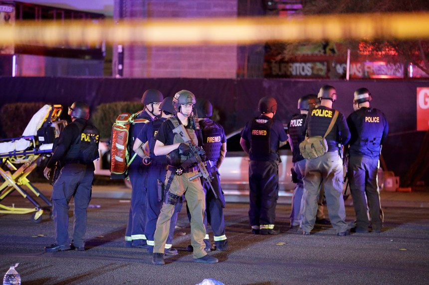 Police officers and medical personnel stand at the scene of a shooting near the Mandalay Bay resort and casino on the Las Vegas Strip on Oct. 2, 2017, in Las Vegas.