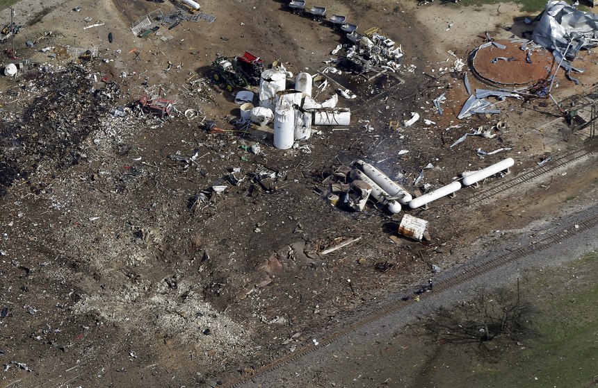 This April 18, 2013, aerial photo shows a crater, bottom left, the the remains of a fertilizer plant destroyed by an explosion in West, Texas. The massive explosion at the West Fertilizer Co. killed at least 14 people and injured more than 160.