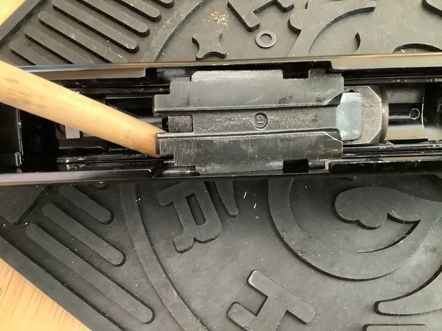 Align the bolt slide with the relief cuts, and pull it out. 
