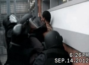 Cop killer Ronell Wilson is forced against a wall when he refuses to be handcuffed before leaving a recreation room. (Photo NY DOC)