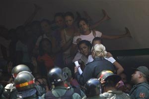 Relatives listen the names of inmates injured during a riot between rival gangs outside of La Planta jail in Caracas, Wednesday, Jan. 27, 2010. (AP photo)