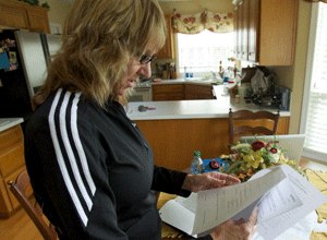 Danielle Tudor, who has kept a file of legal documents on the Richard Troy Gillmore case, fought in 2012 to be allowed to speak at Gillmore's parole hearing. (Photo The Oregonian)