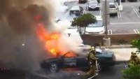 Car explodes while firefighter fights fire