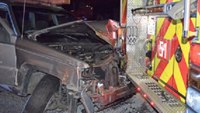Driver slams SUV into fire truck, police car