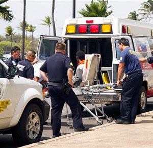 A 16-year-old boy who stowed away in the wheel well of a flight from San Jose, Calif., to Maui, on stretcher at center, is loaded into an ambulance at Kahului Airport in Kahului, Maui, Hawaii Sunday afternoon, April 20, 2014. (AP Photo/The News, Chris Sugidono)